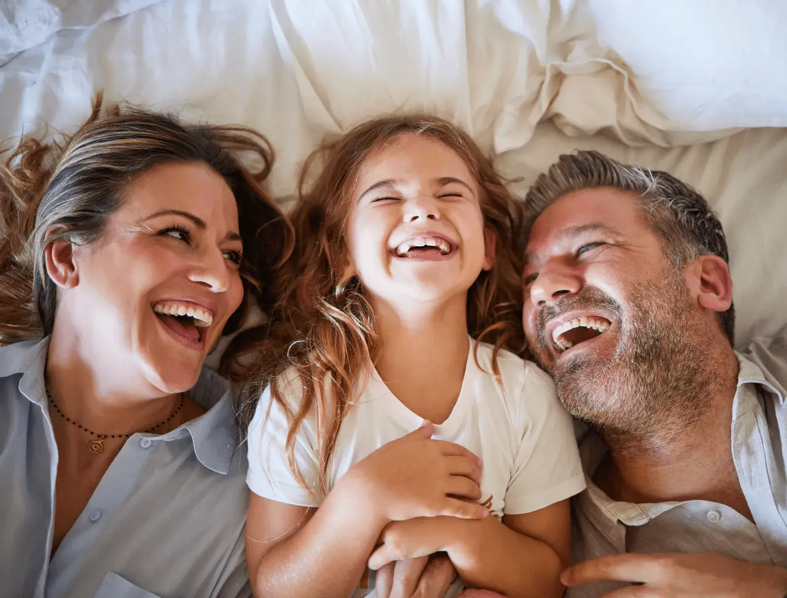 Happy family laughing together at London Square Dental Centre, trusted family dentist in Calgary